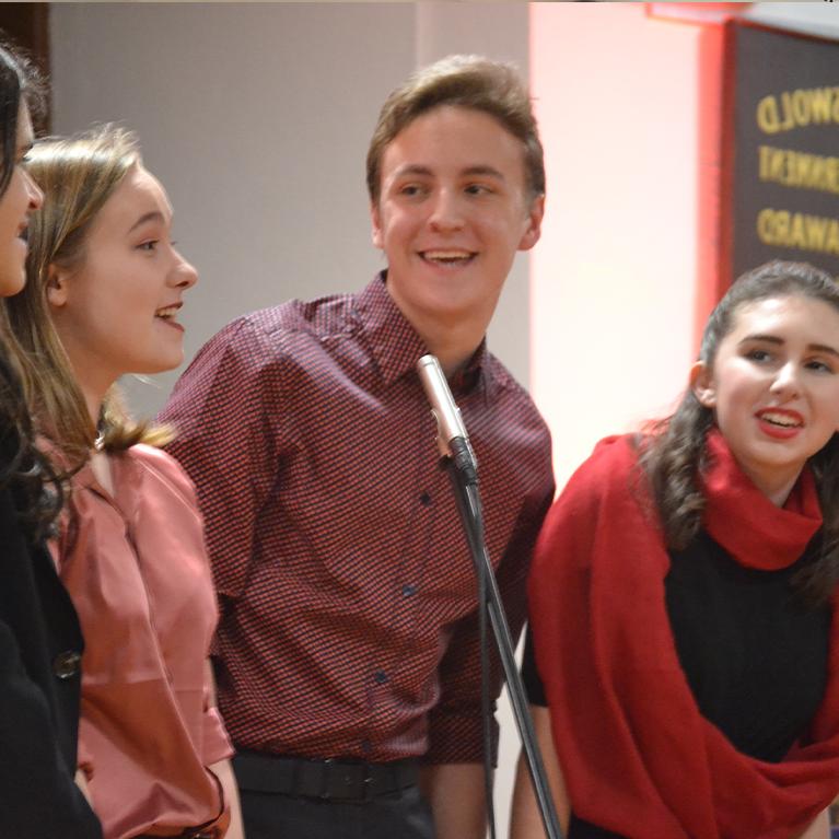 A small group of choir students sing at Chase Collegiate School.